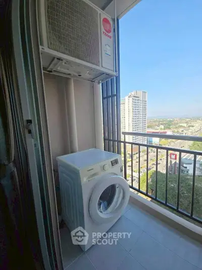 High-rise apartment balcony with washing machine and city view