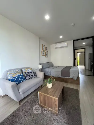 Modern studio apartment with cozy living area and stylish decor