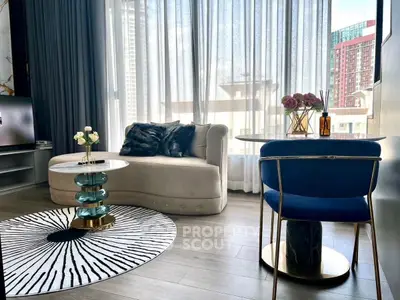 Luxurious modern living room with elegant furniture and large windows offering city views.