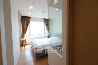 Bright and airy bedroom with large window and modern furnishings