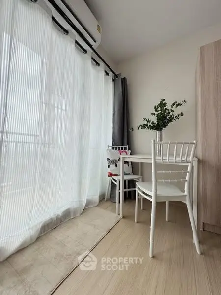 Bright and airy corner dining area with natural light and modern decor.