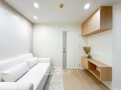 Modern minimalist living room with white sofa and wooden accents