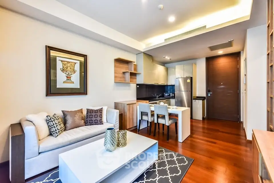 Modern living room with open kitchen, stylish decor, and hardwood floors in a cozy apartment.
