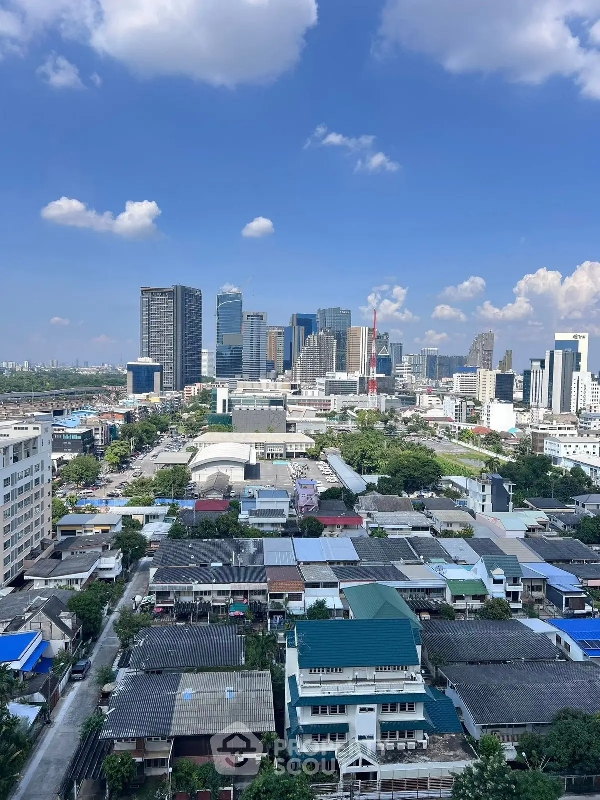 Stunning cityscape view showcasing modern skyscrapers and residential areas under a clear blue sky.