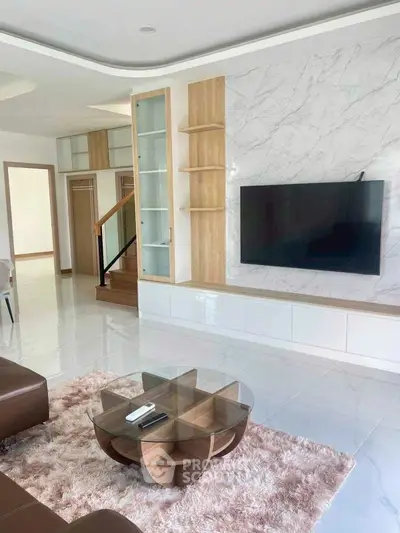 Modern living room with sleek TV setup and stylish furniture, perfect for contemporary living.