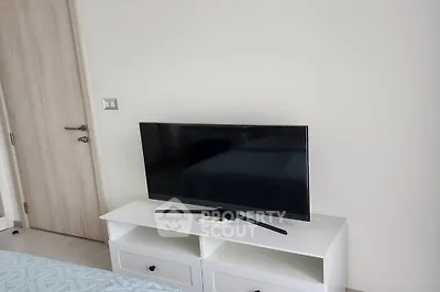 Modern bedroom with sleek TV setup and minimalist decor
