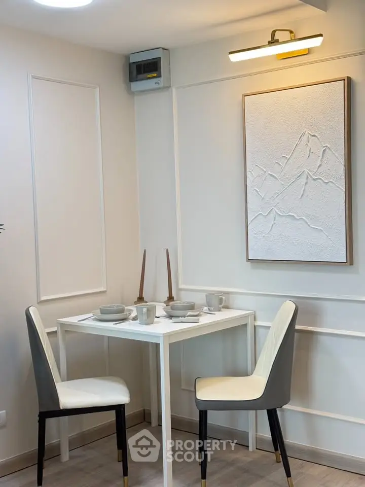 Chic dining nook with modern decor and elegant wall art in a cozy apartment corner.