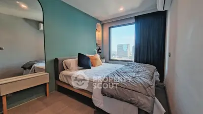 Modern bedroom with large window and stylish decor, offering a cozy and inviting atmosphere.