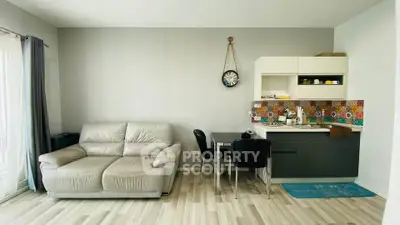 Modern living room with stylish kitchenette and cozy seating area