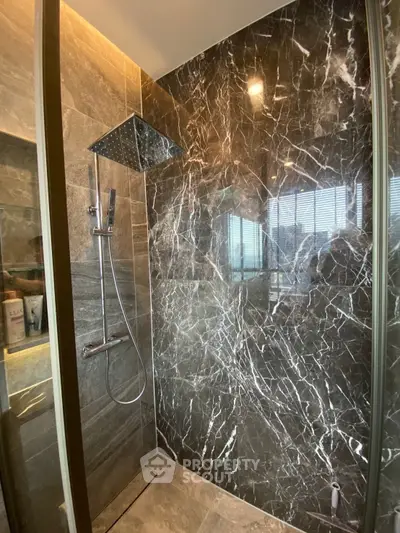 Luxurious modern bathroom with marble shower and sleek fixtures