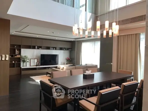 Luxurious modern living room with high ceilings and elegant dining area