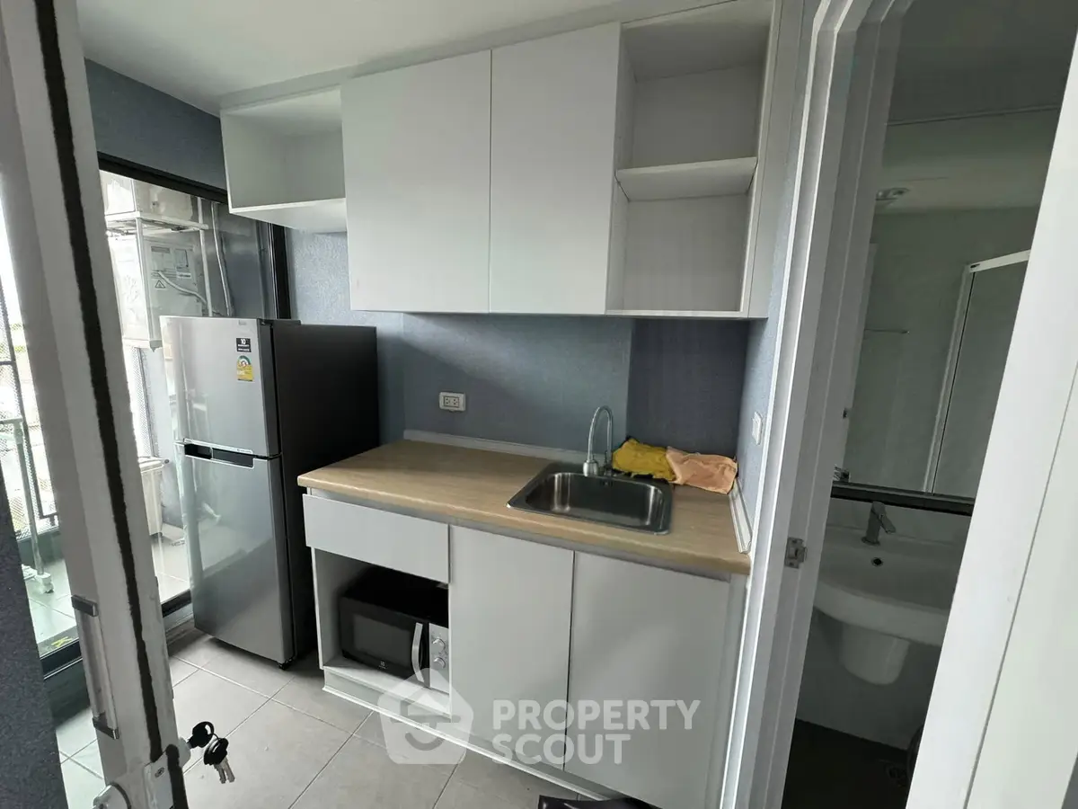 Modern kitchen with sleek cabinetry and stainless steel appliances in a compact layout.