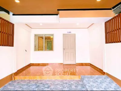 Spacious garage with tiled flooring and modern lighting in a residential property.