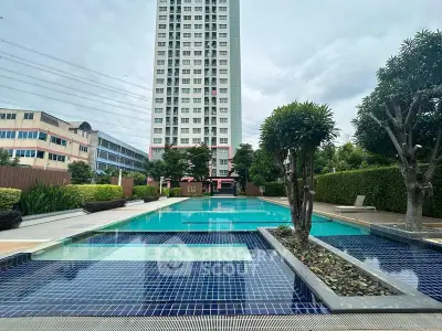 Luxurious condominium with stunning pool and lush greenery, perfect for modern living.