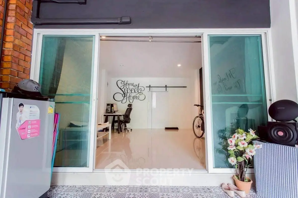 Modern interior with sliding glass doors, sleek flooring, and stylish decor in a cozy living space.