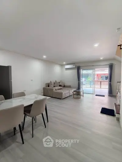 Spacious modern living room with elegant furniture and large windows for natural light.