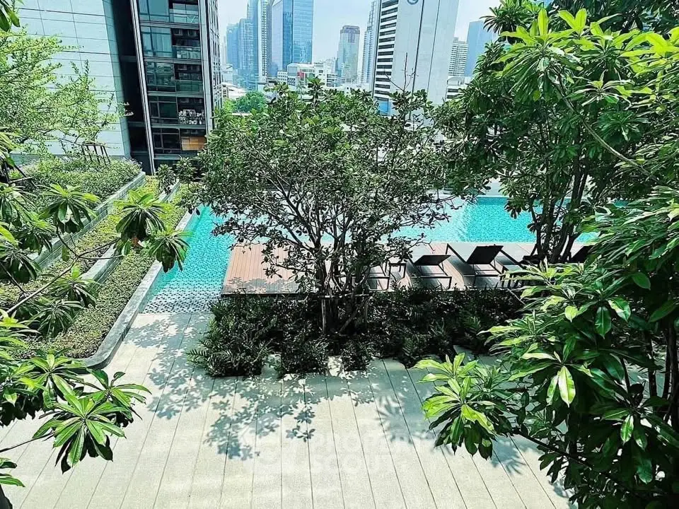 Luxurious urban poolside oasis with lush greenery and city skyline views.