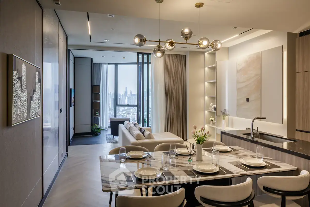 Luxurious open-plan kitchen and living room with city view, modern decor, and elegant lighting.