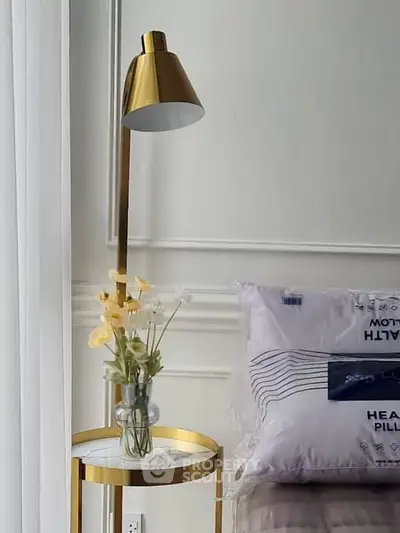 Elegant bedroom corner with modern lamp and floral decor on side table