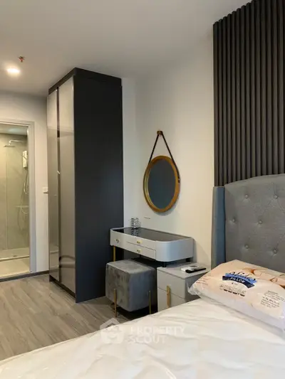Modern bedroom with stylish decor and ensuite bathroom in a contemporary apartment.