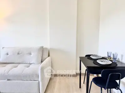 Modern living room with cozy sofa and stylish dining area in a bright apartment.