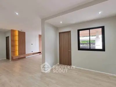 Modern minimalist interior with wooden flooring and sleek design elements.
