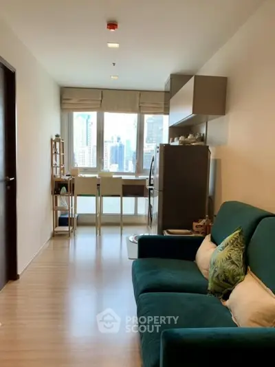 Modern living room with city view, featuring stylish furniture and open layout.