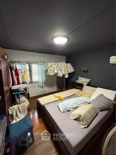 Cozy bedroom with wooden flooring and ample natural light