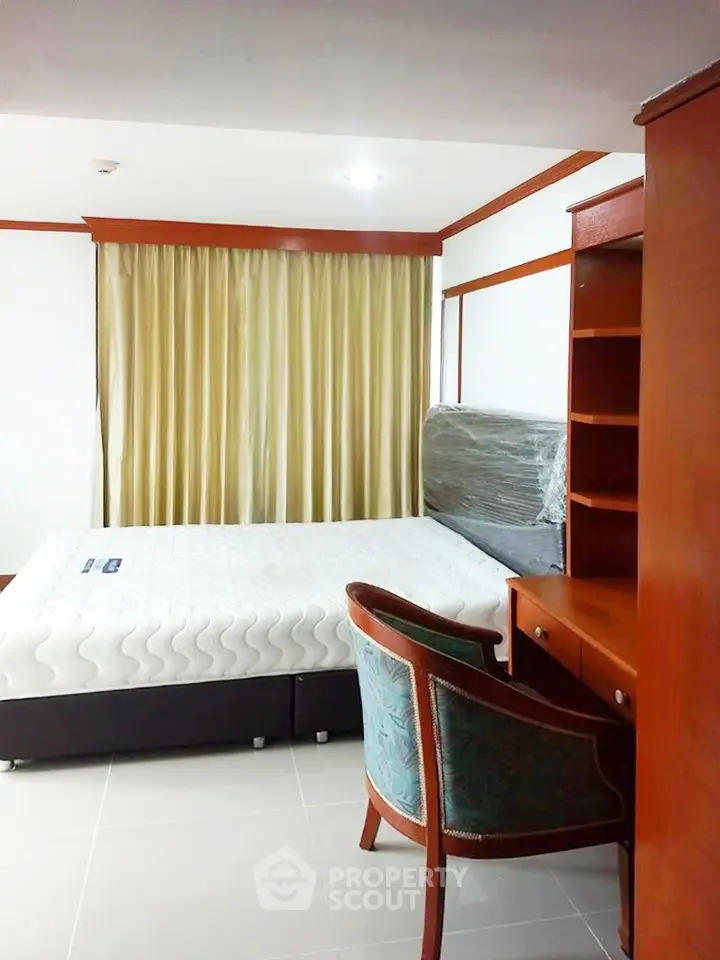 Spacious bedroom with elegant wooden furniture and natural light