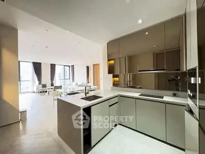 Modern open-layout kitchen with sleek cabinetry and spacious living area