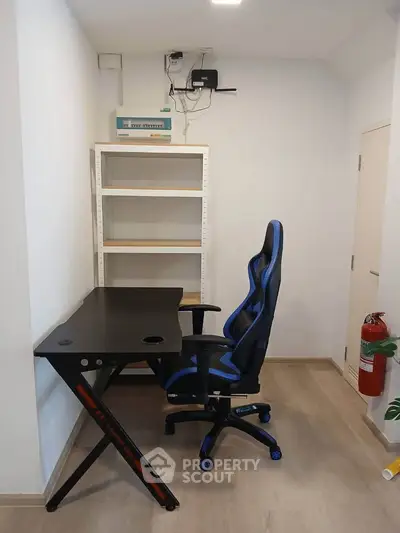 Compact study room with modern desk and gaming chair, ideal for productivity and comfort.