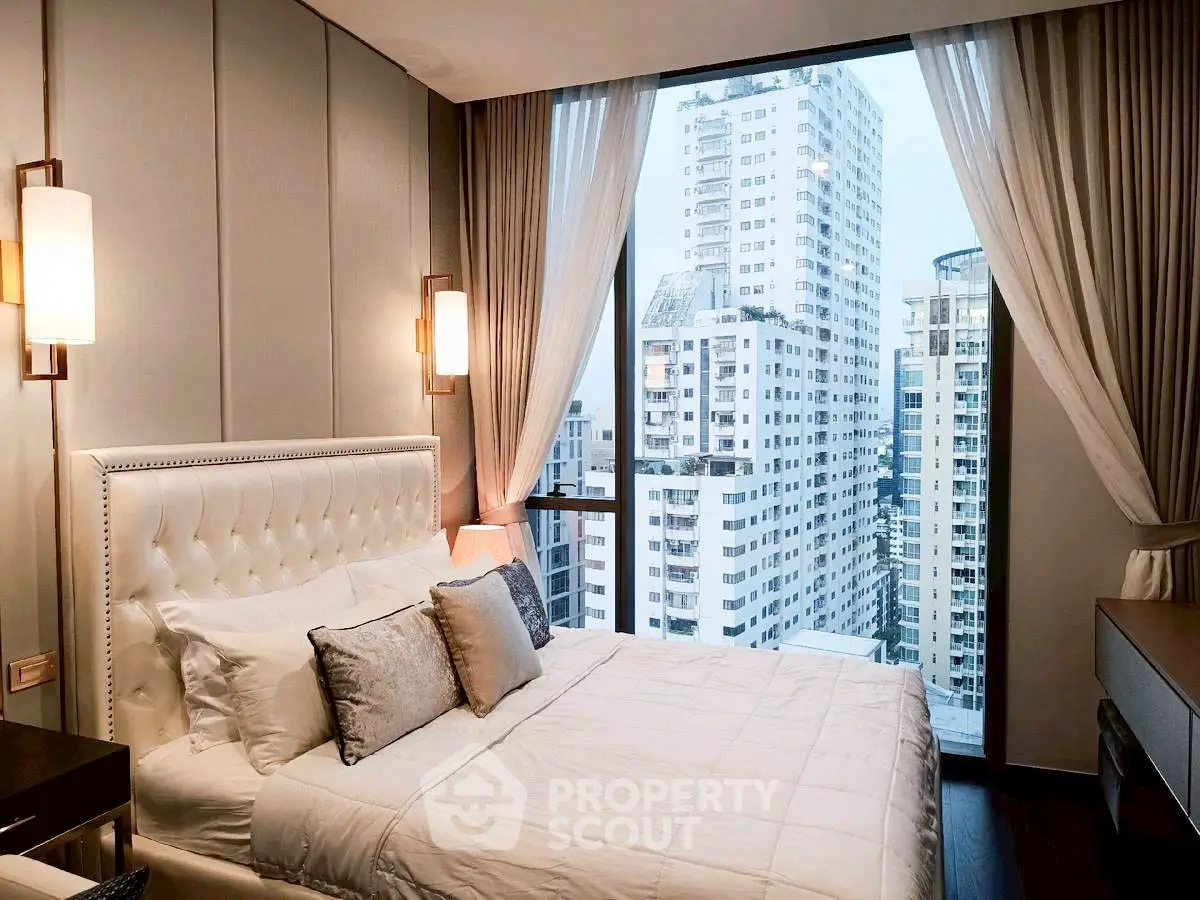 Luxurious bedroom with stunning city view in modern high-rise apartment.