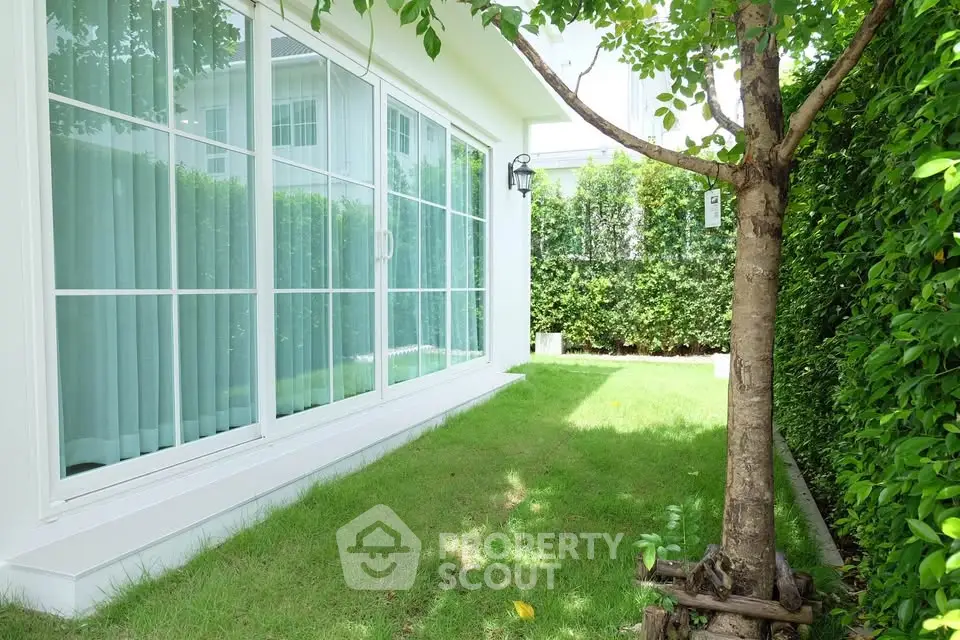 Charming garden view with lush greenery and modern glass doors