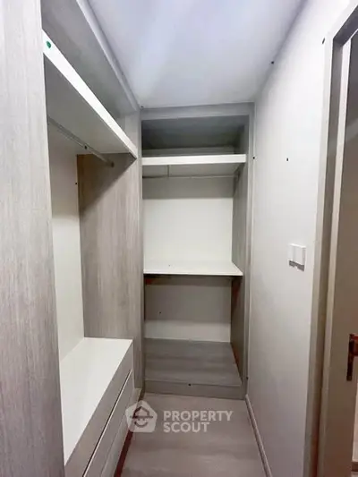 Spacious walk-in closet with modern shelving and storage solutions.