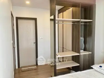 Modern bedroom with stylish open wardrobe and sleek wooden flooring