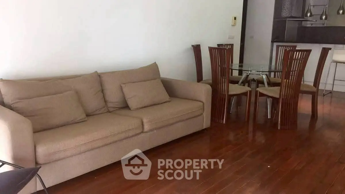 Spacious living room with elegant dining area and cozy sofa, perfect for modern living.