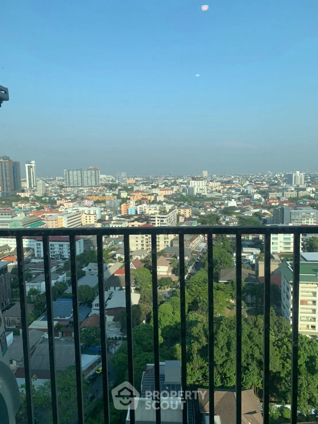 Stunning cityscape view from a high-rise balcony, showcasing urban living at its finest.