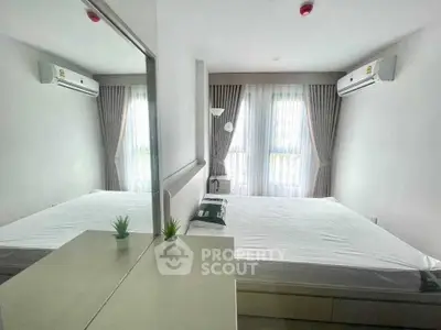 Modern bedroom with large windows and air conditioning units, featuring a minimalist design.