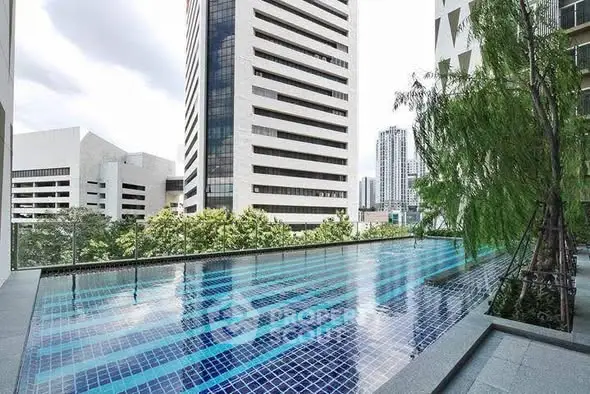 Luxurious high-rise building with stunning rooftop pool and city views.