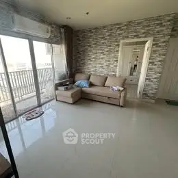 Spacious living room with modern decor and balcony access