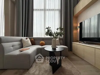 Stylish modern living room with elegant decor and large TV