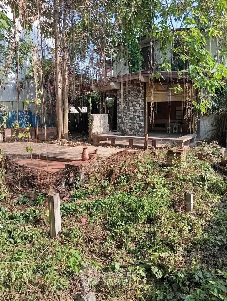 Charming rustic house with stone facade and lush greenery, perfect for nature lovers seeking tranquility.