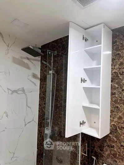 Modern bathroom with marble walls and sleek shower design