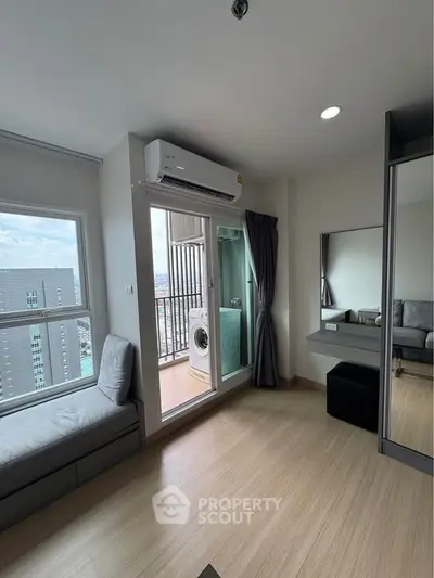 Modern apartment interior with balcony view and washing machine, featuring sleek design and ample natural light.