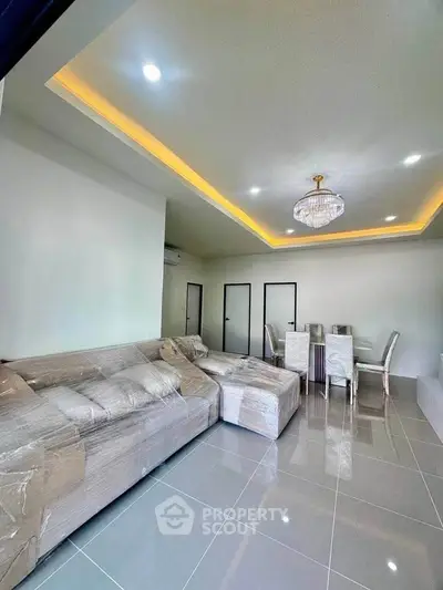 Modern living room with elegant chandelier and spacious seating area