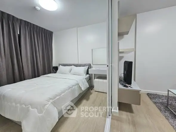 Modern bedroom with cozy bed and stylish decor in a contemporary apartment.