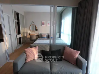 Modern studio apartment with cozy living area and stylish bedroom decor.