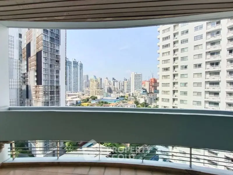 Stunning cityscape view from a spacious balcony in a modern high-rise apartment.