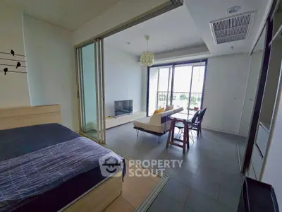 Modern open-plan living room with balcony view and stylish furniture