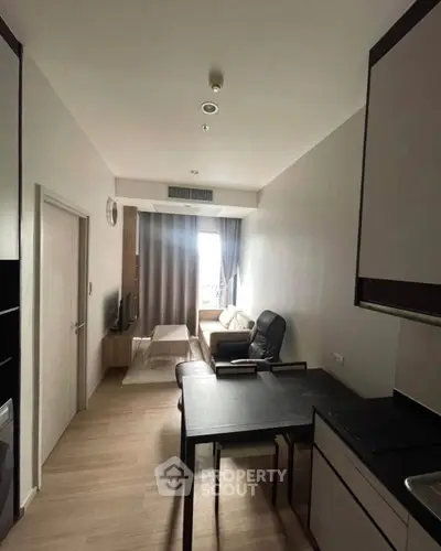 Modern compact living room with sleek furniture and natural light